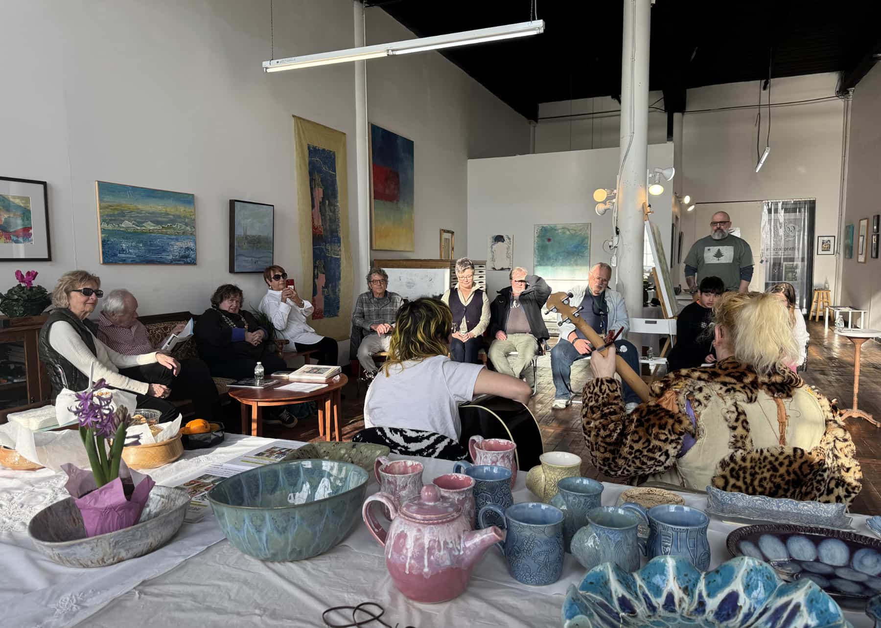 A music circle with musicians playing music in a studio space at Kilburn Mill